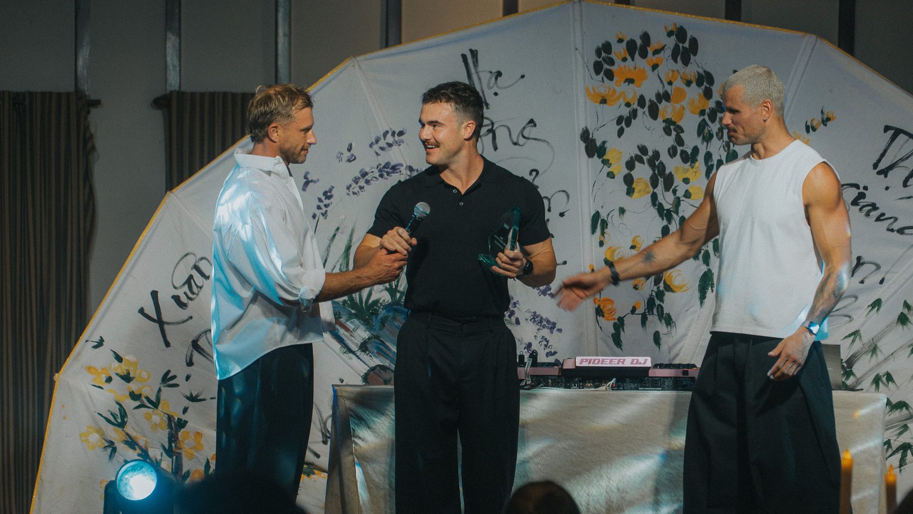 Ben Woolford handing an award over on stage at the awards night