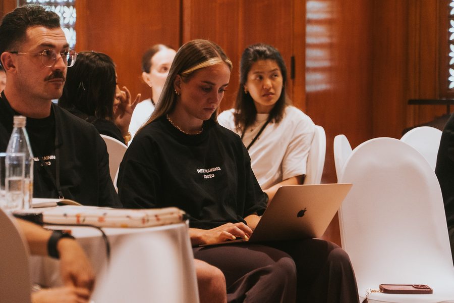 A studio manager working through a session on her laptop